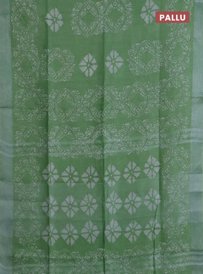 Pure linen saree teal green shade with allover batik prints and silver zari woven border