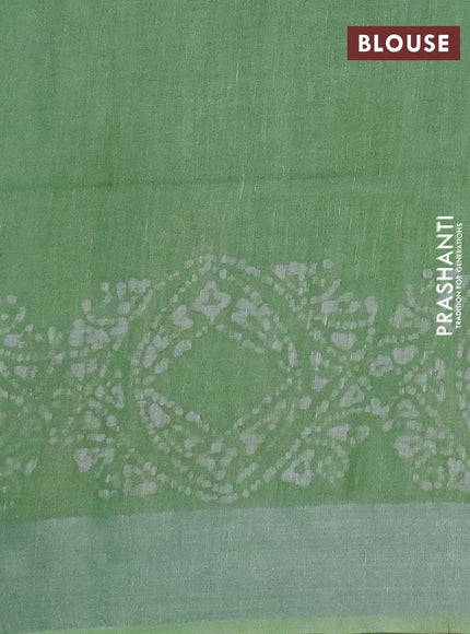 Pure linen saree teal green shade with allover batik prints and silver zari woven border