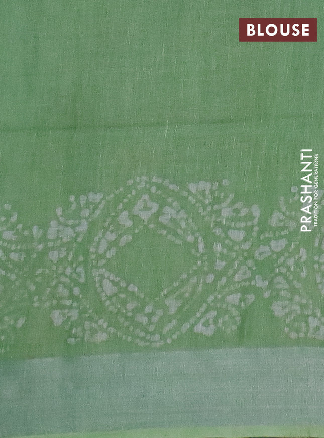 Pure linen saree teal green shade with allover batik prints and silver zari woven border