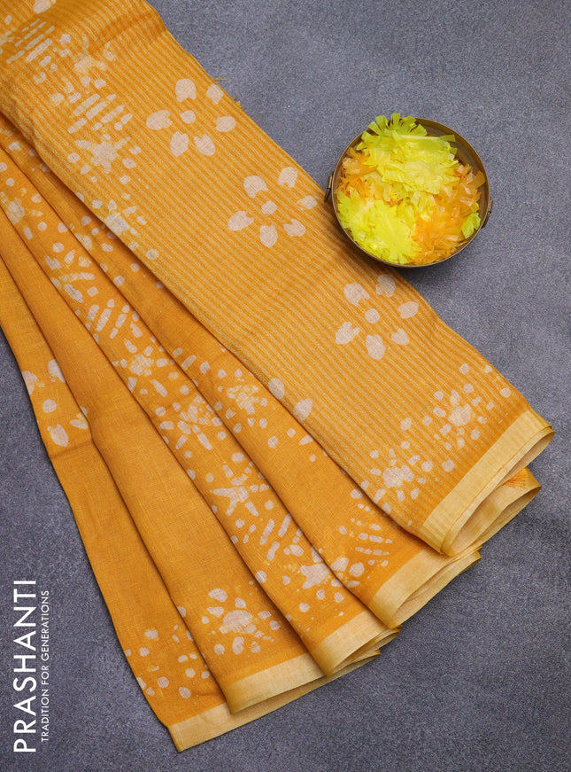 Pure linen saree mustard yellow with batik butta prints and silver zari woven border