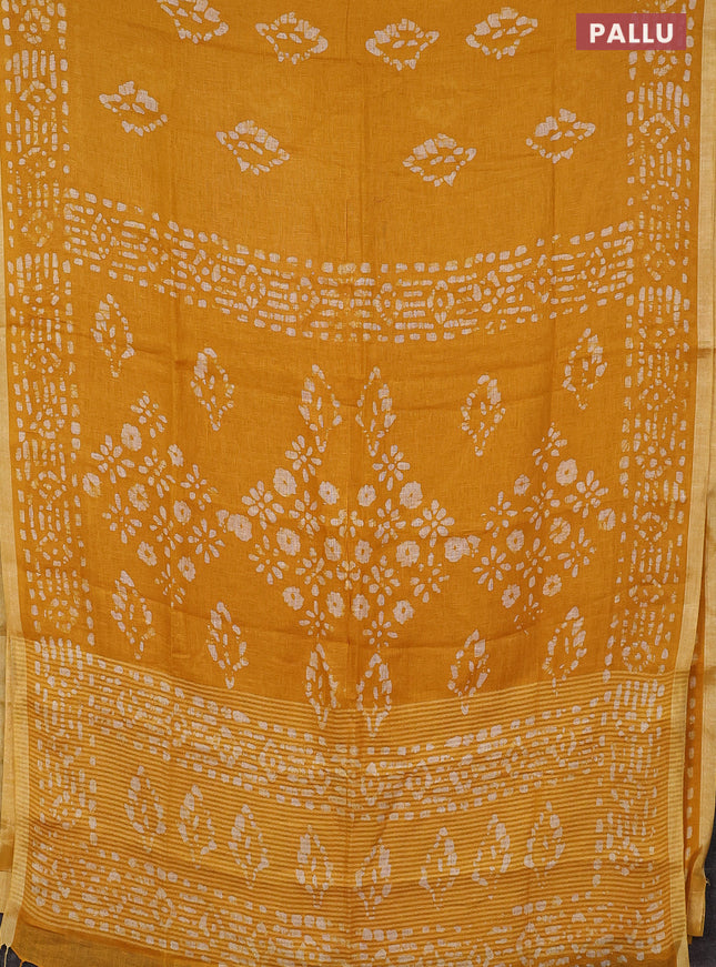 Pure linen saree yellow with allover batik prints and silver zari woven border