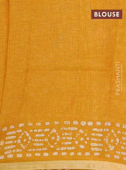 Pure linen saree yellow with allover batik prints and silver zari woven border