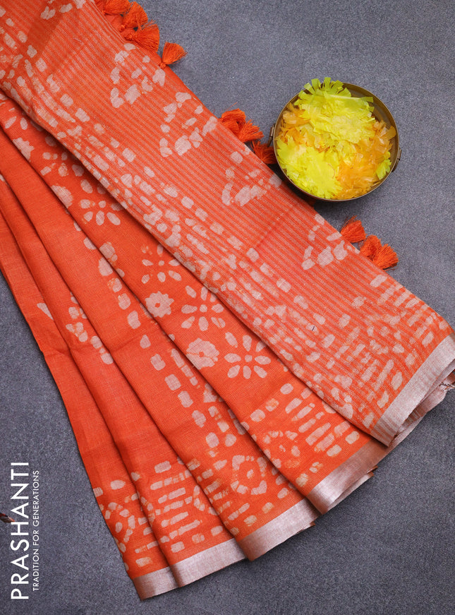 Pure linen saree orange with allover batik prints and silver zari woven border