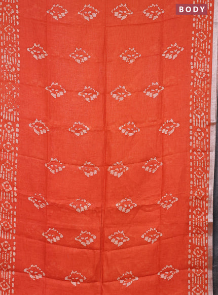 Pure linen saree orange with allover batik prints and silver zari woven border