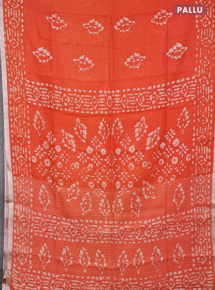 Pure linen saree orange with allover batik prints and silver zari woven border