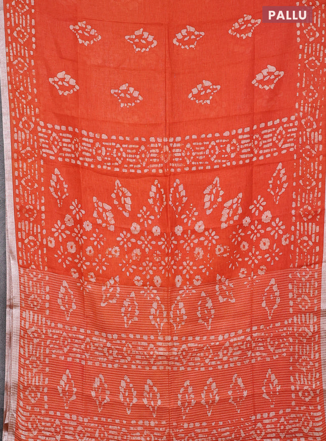 Pure linen saree orange with allover batik prints and silver zari woven border
