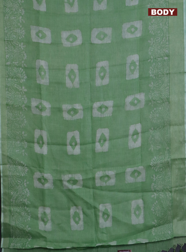 Pure linen saree light green with allover batik prints and zari woven border