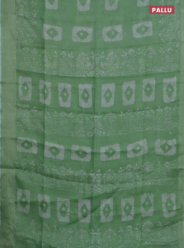 Pure linen saree light green with allover batik prints and zari woven border