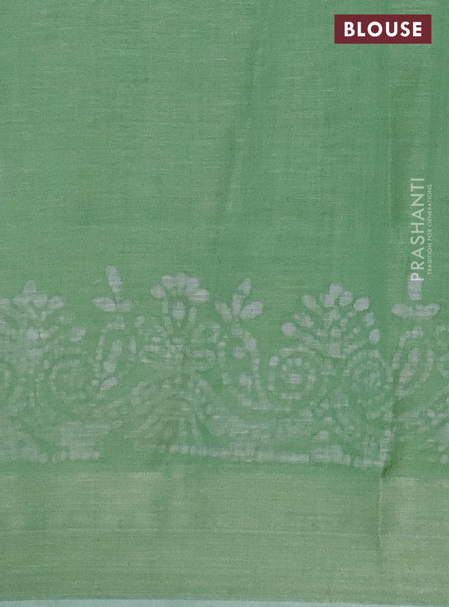 Pure linen saree light green with allover batik prints and zari woven border