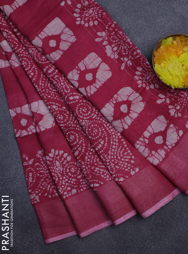 Pure linen saree dark pink with allover batik prints and zari woven border