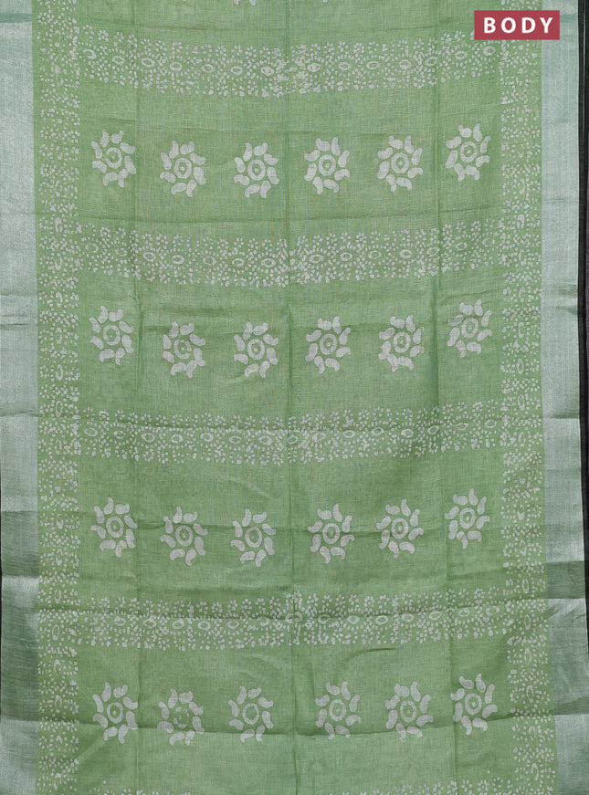 Pure linen saree green shade and black with allover batik prints and silver zari woven border