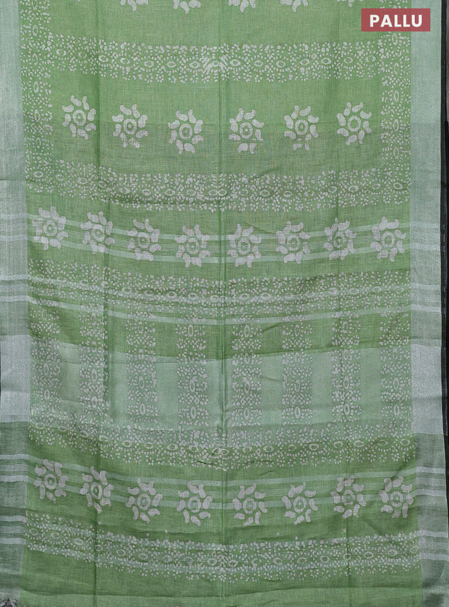 Pure linen saree green shade and black with allover batik prints and silver zari woven border
