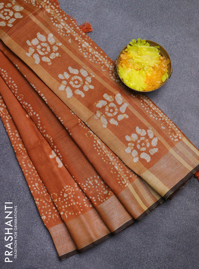 Pure linen saree dark mustard and black with allover batik prints and silver zari woven border