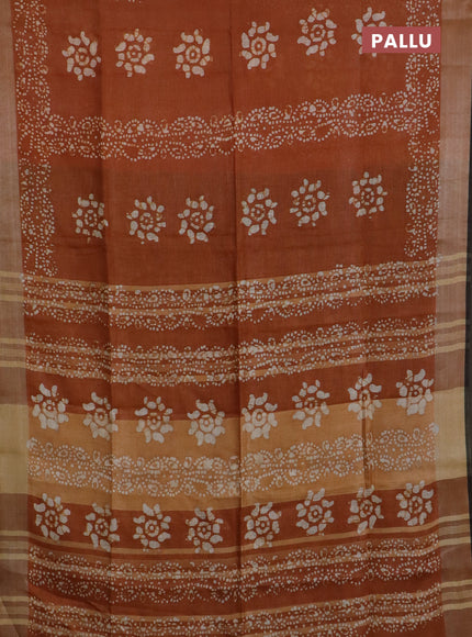 Pure linen saree dark mustard and black with allover batik prints and silver zari woven border