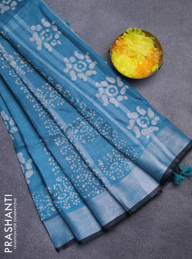 Pure linen saree teal blue shade and black with allover batik prints and silver zari woven border