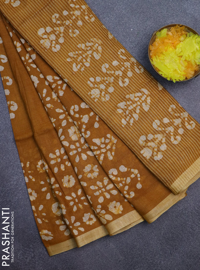 Pure linen saree dark mustard with allover batik prints and silver zari woven border