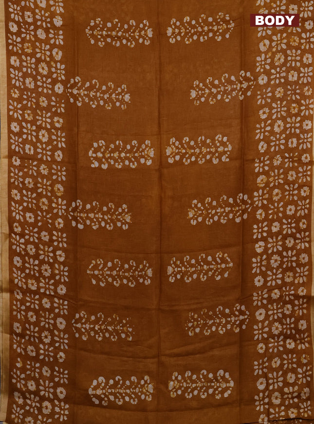 Pure linen saree dark mustard with allover batik prints and silver zari woven border