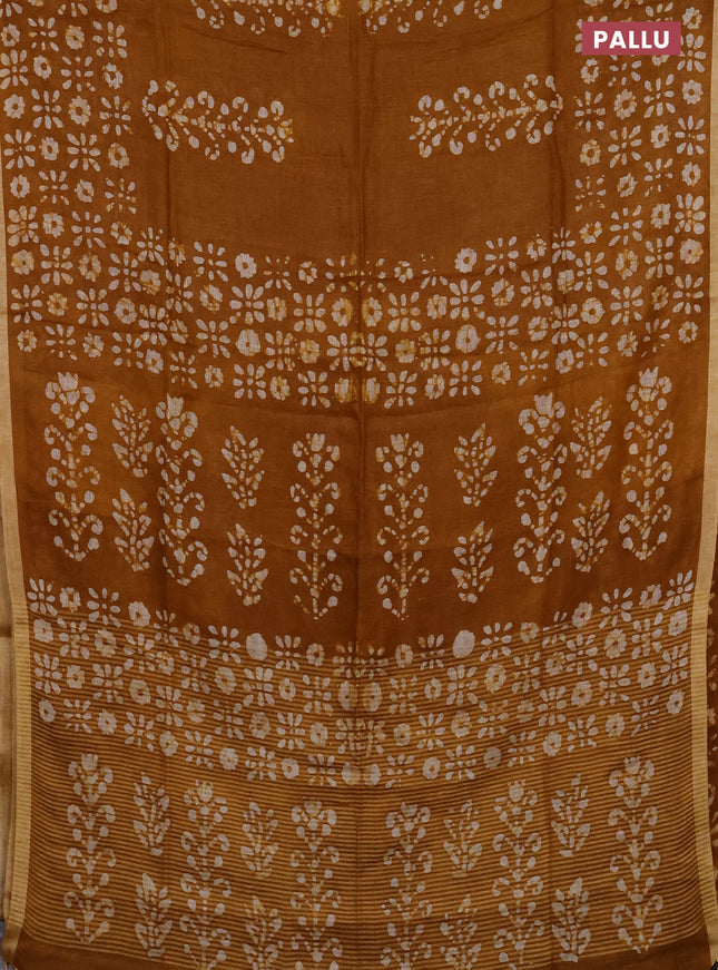 Pure linen saree dark mustard with allover batik prints and silver zari woven border
