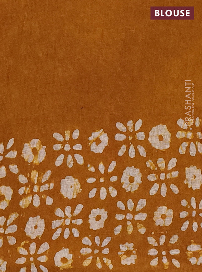 Pure linen saree dark mustard with allover batik prints and silver zari woven border