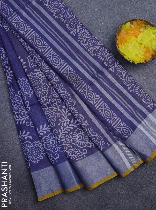Pure linen saree blue shade with allover prints and silver zari woven border