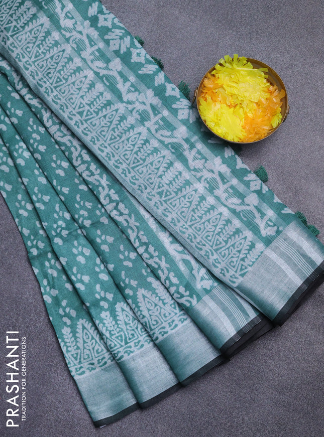 Pure linen saree teal green and black with allover prints and silver zari woven border