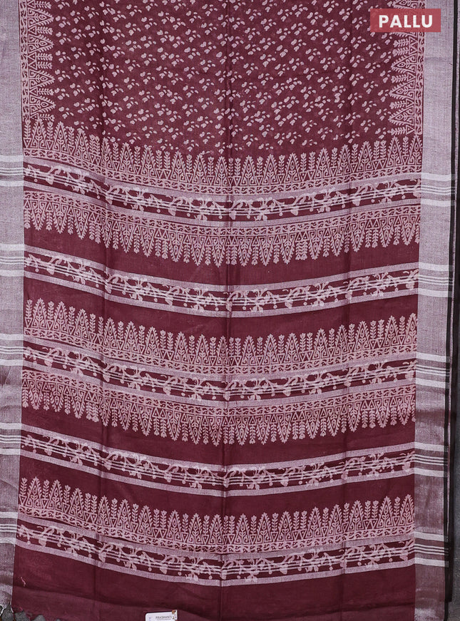 Pure linen saree deep maroon with allover prints and silver zari woven border