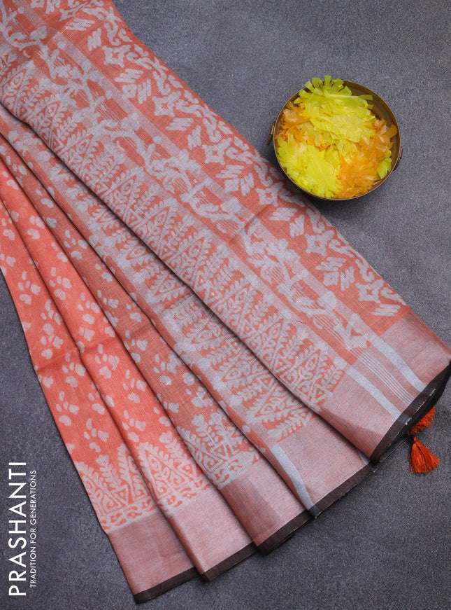 Pure linen saree orange and black with allover prints and silver zari woven border