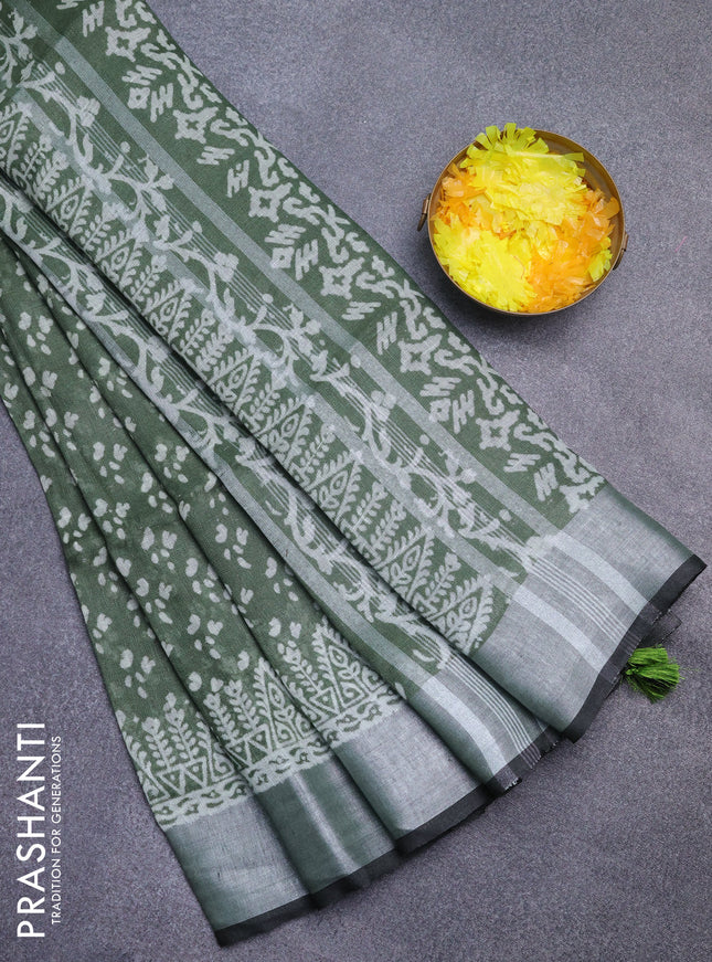 Pure linen saree sap green with allover prints and silver zari woven border