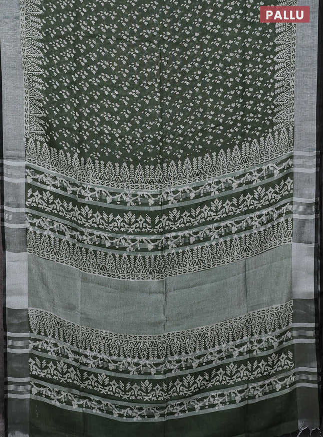 Pure linen saree sap green with allover prints and silver zari woven border