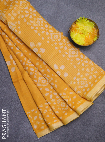 Pure linen saree yellow with batik butta prints and silver zari woven border