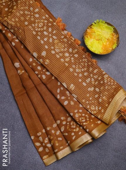 Pure linen saree dark mustard with batik butta prints and silver zari woven border