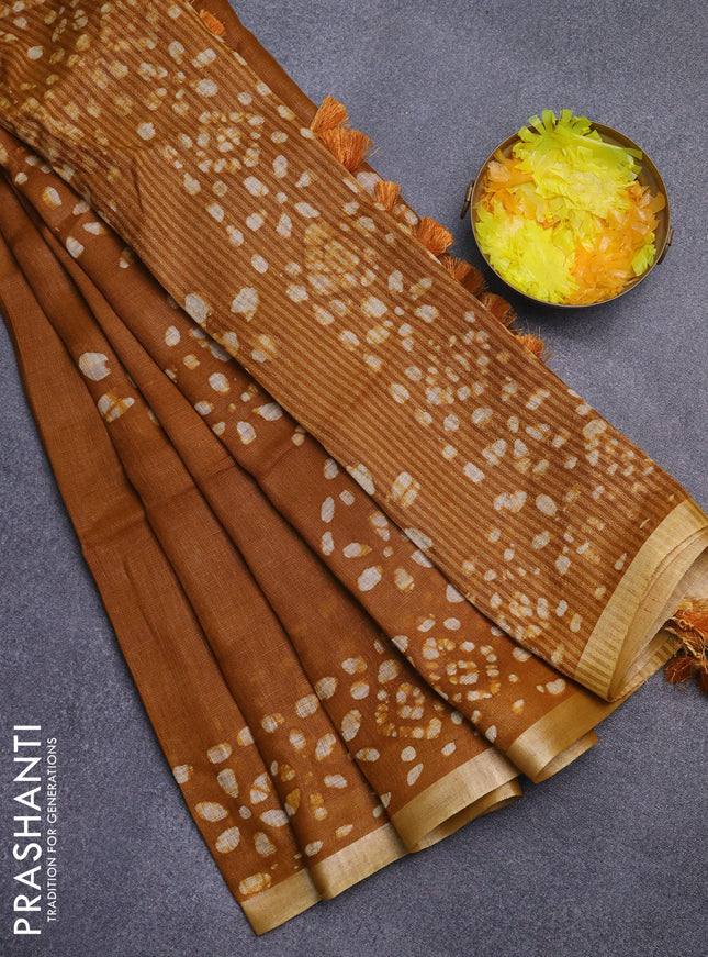 Pure linen saree dark mustard with batik butta prints and silver zari woven border