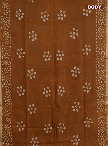 Pure linen saree dark mustard with batik butta prints and silver zari woven border
