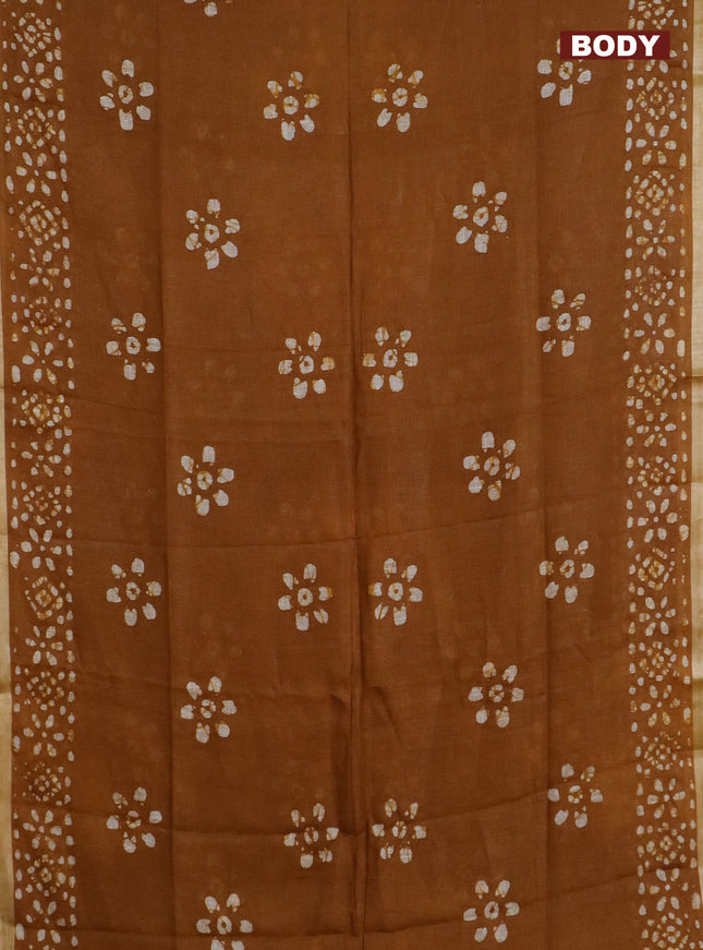 Pure linen saree dark mustard with batik butta prints and silver zari woven border