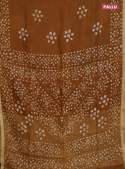 Pure linen saree dark mustard with batik butta prints and silver zari woven border