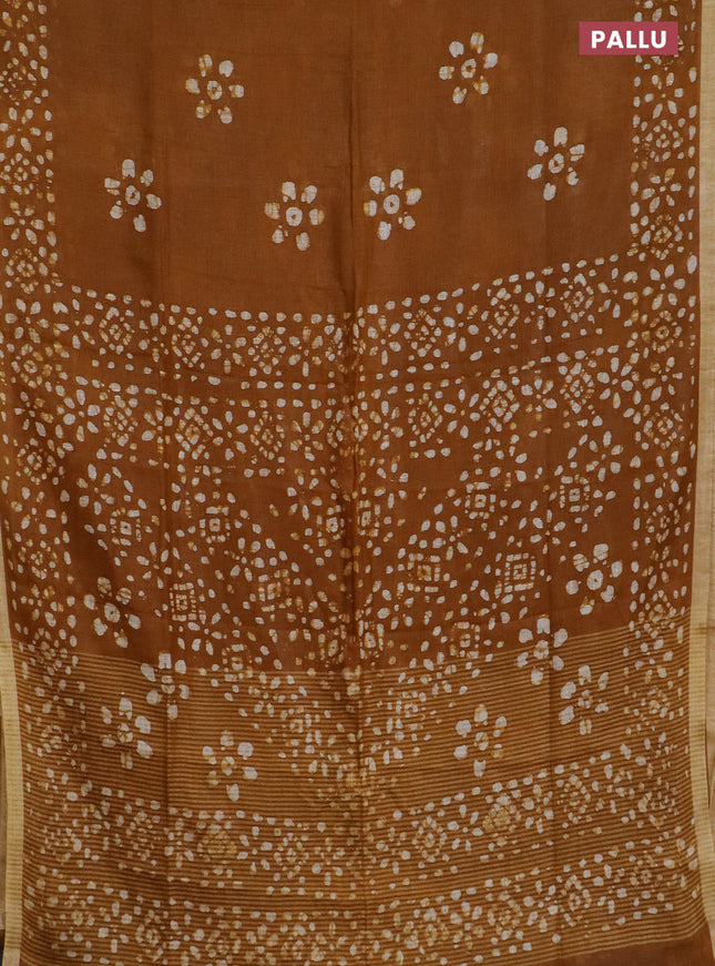 Pure linen saree dark mustard with batik butta prints and silver zari woven border