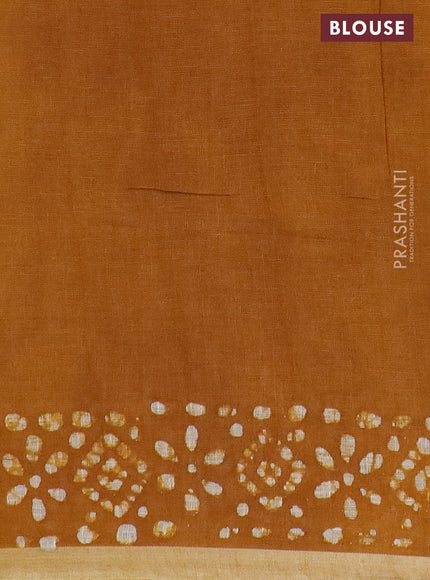 Pure linen saree dark mustard with batik butta prints and silver zari woven border