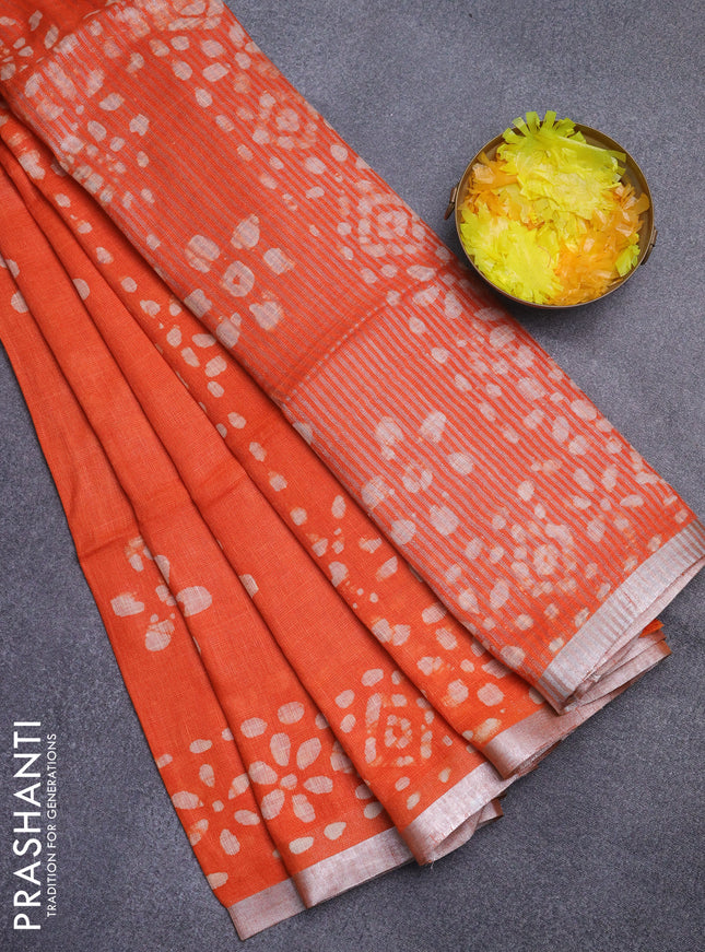 Pure linen saree orange with batik butta prints and silver zari woven border