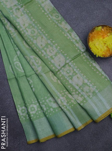 Pure linen saree green shade and yellow with batik butta prints and silver zari woven border