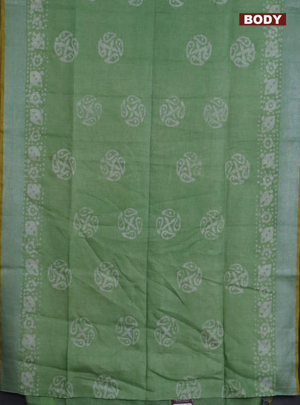 Pure linen saree green shade and yellow with batik butta prints and silver zari woven border