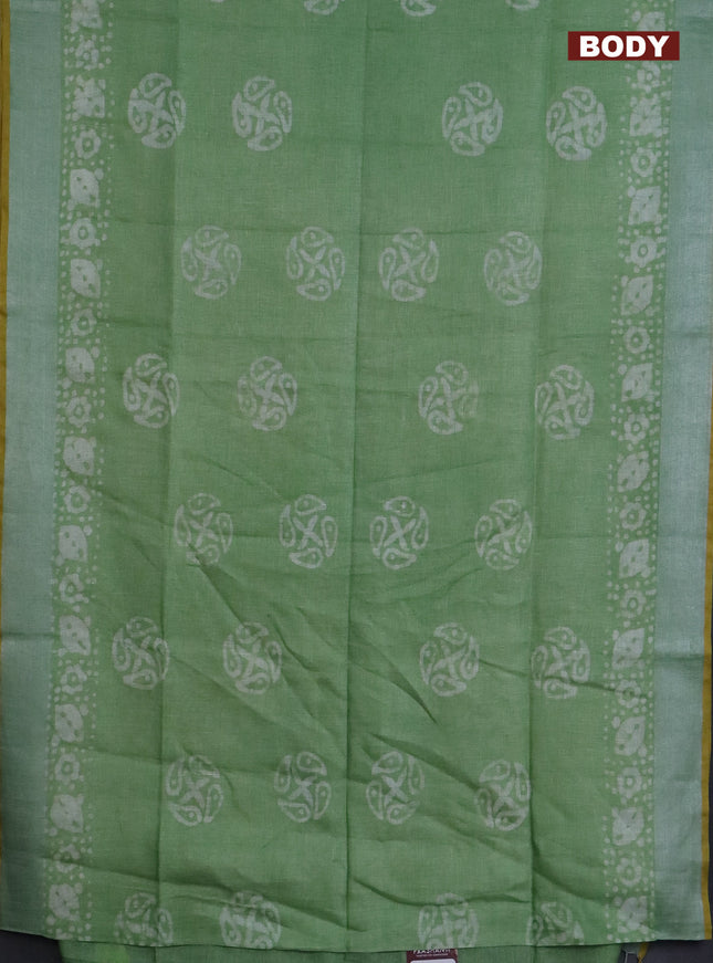 Pure linen saree green shade and yellow with batik butta prints and silver zari woven border