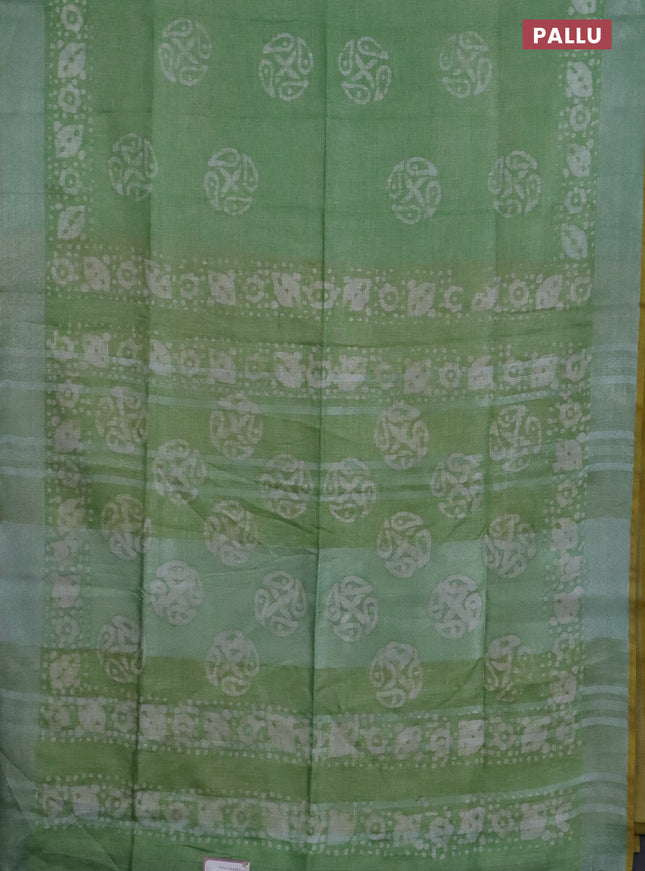 Pure linen saree green shade and yellow with batik butta prints and silver zari woven border