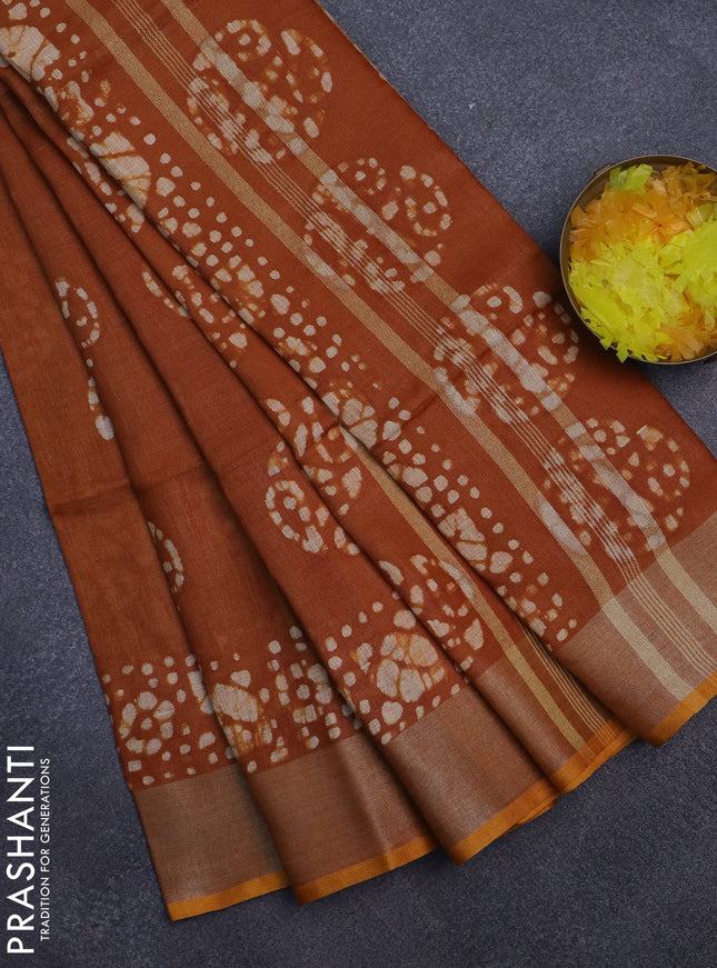 Pure linen saree rust shade with batik butta prints and silver zari woven border