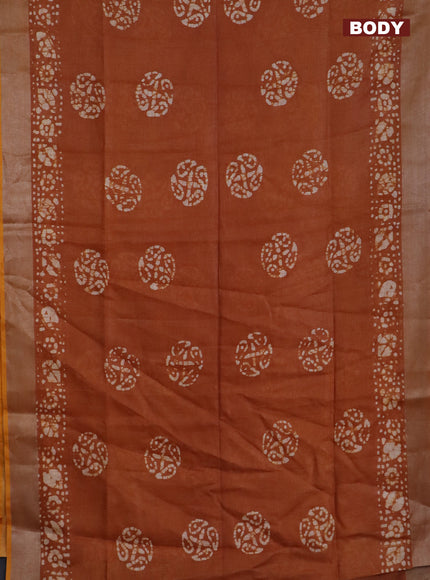 Pure linen saree rust shade with batik butta prints and silver zari woven border