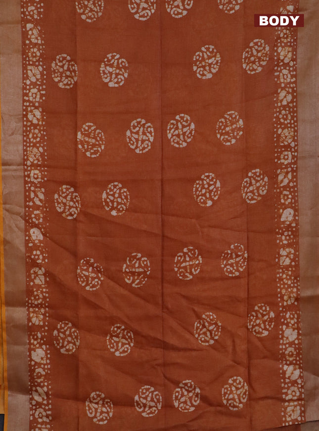 Pure linen saree rust shade with batik butta prints and silver zari woven border