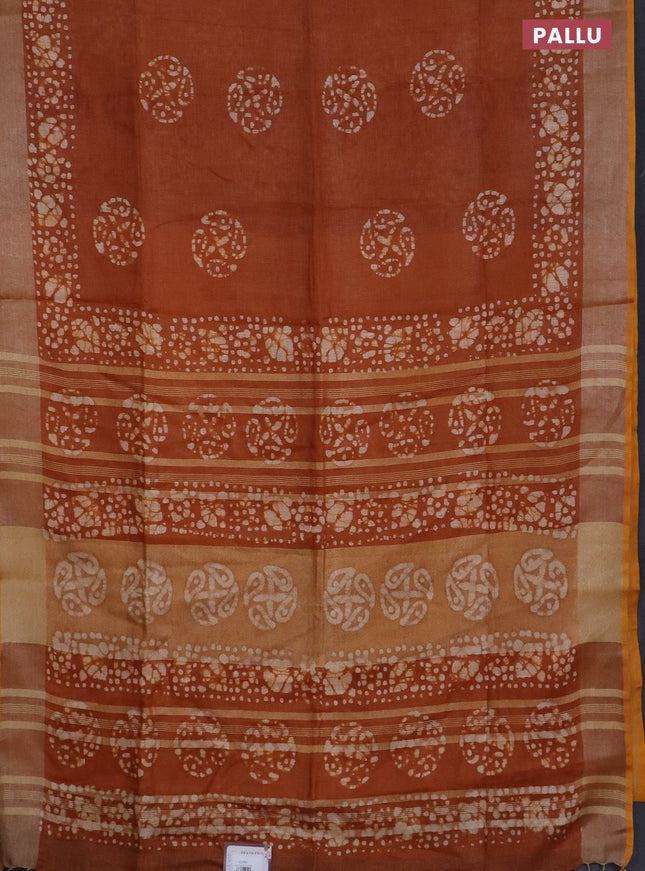 Pure linen saree rust shade with batik butta prints and silver zari woven border