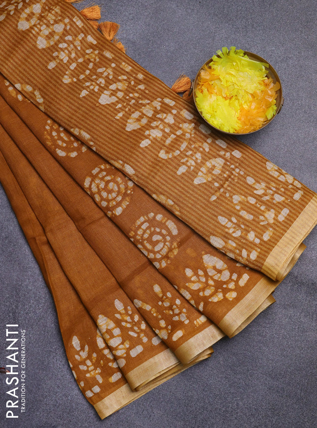 Pure linen saree dark mustard with batik butta prints and silver zari woven border