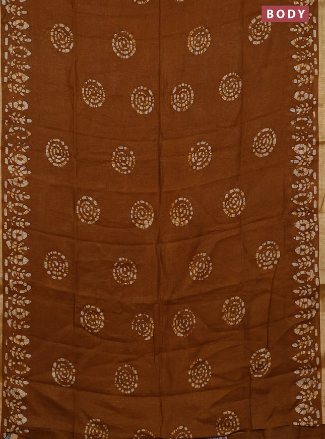 Pure linen saree dark mustard with batik butta prints and silver zari woven border