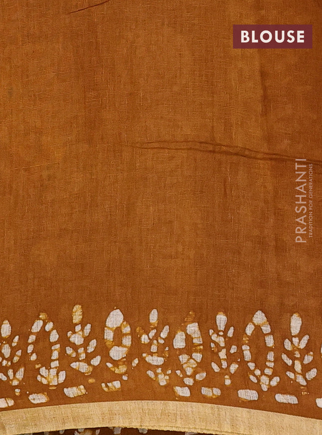 Pure linen saree dark mustard with batik butta prints and silver zari woven border