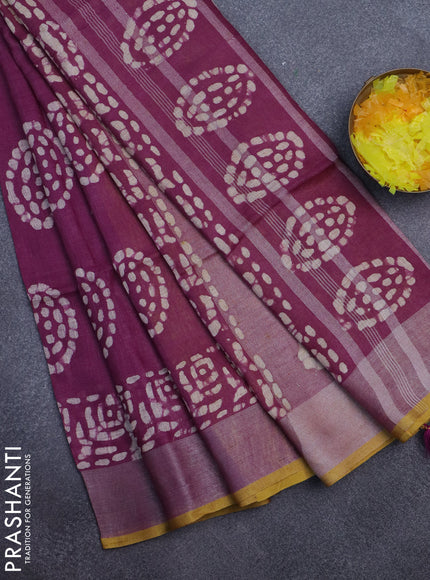 Pure linen saree wine shade with batik prints and silver zari woven border